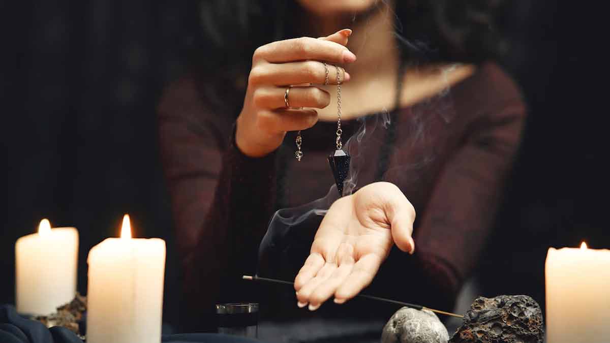 Astrologer reading a birth chart beneath a star-filled sky